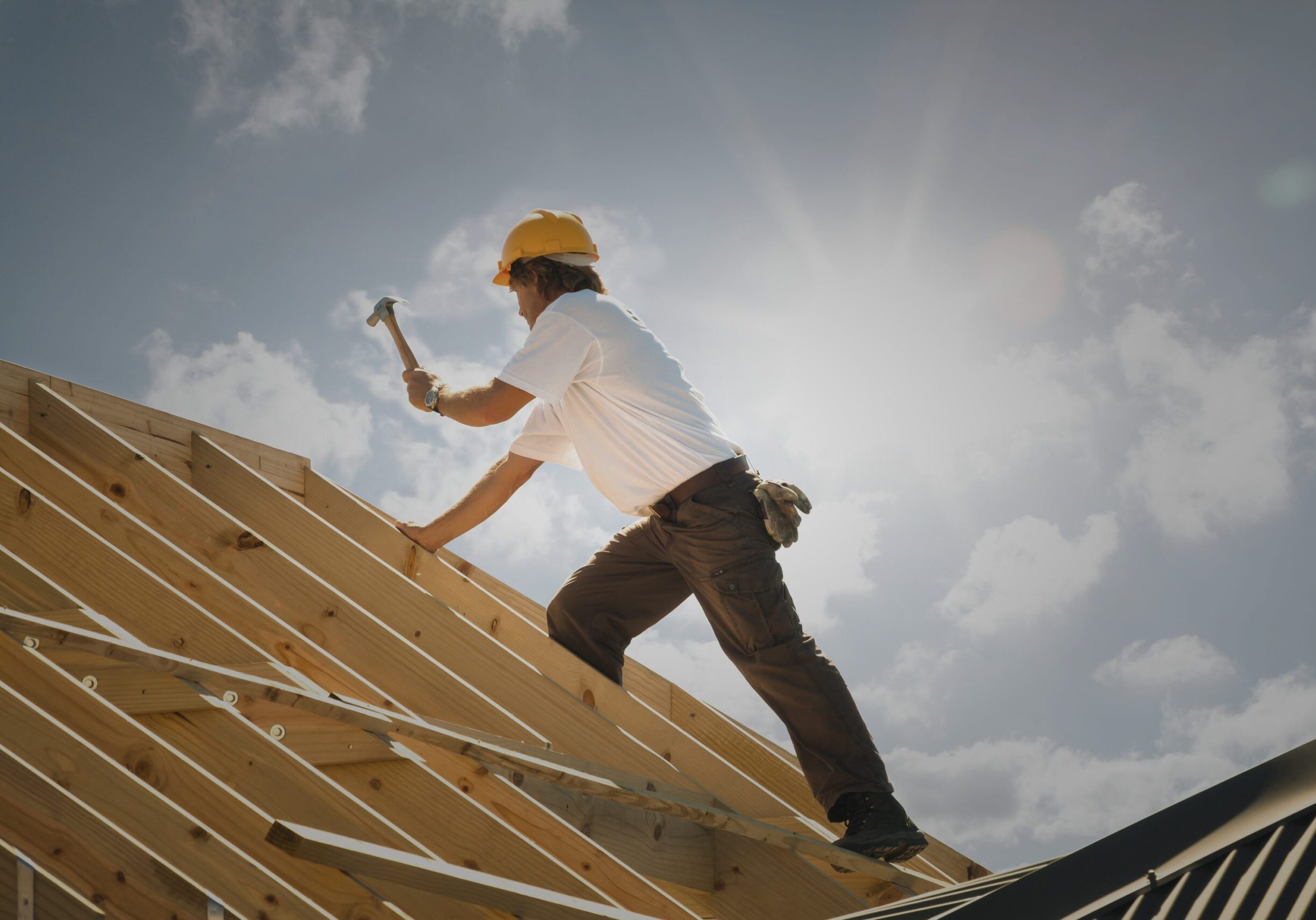 Carpenter framing a roof under construction